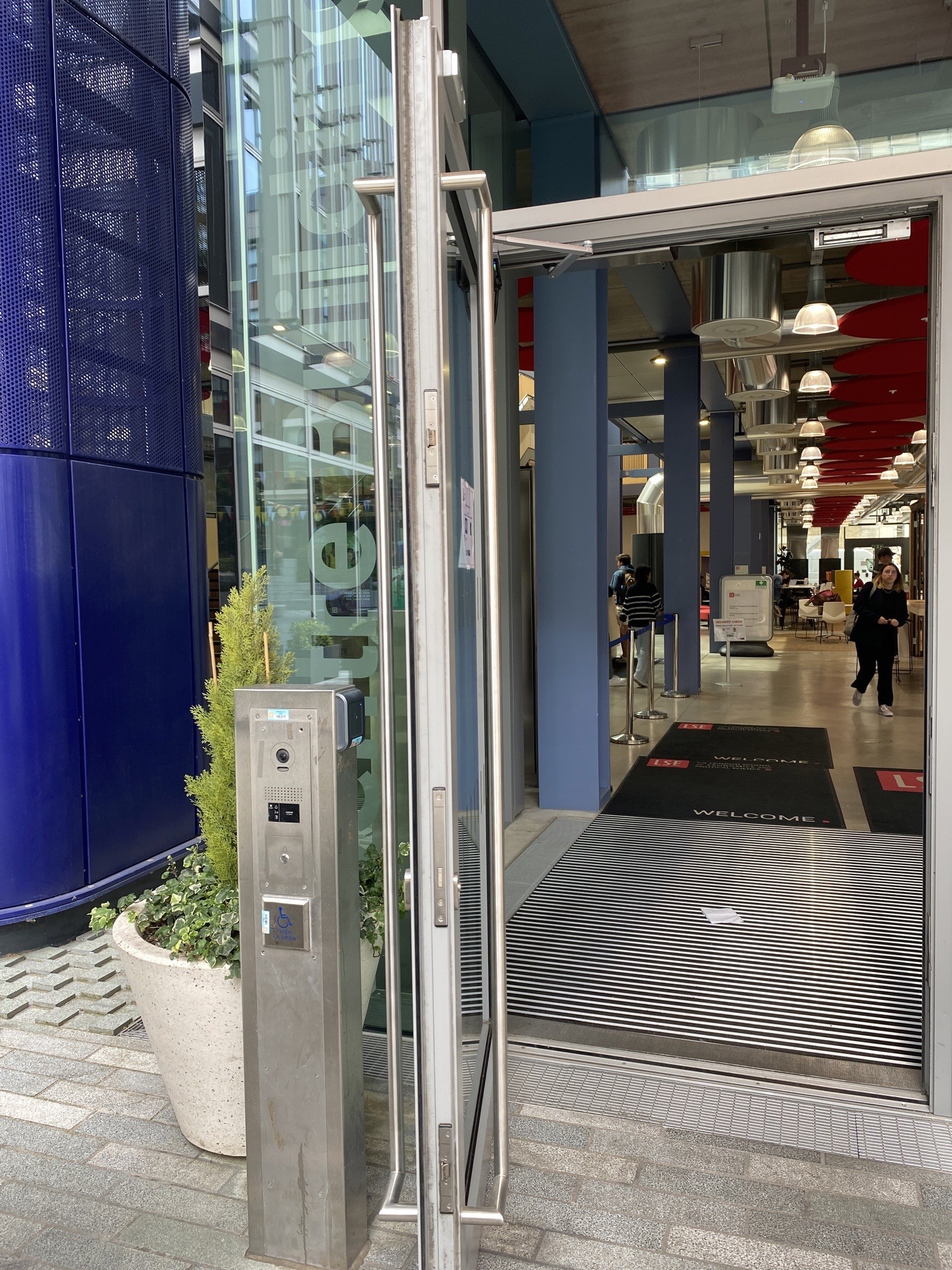 This is the automatic door to the left of the entrance. It opens outwards and stays open for atleast 7 seconds.