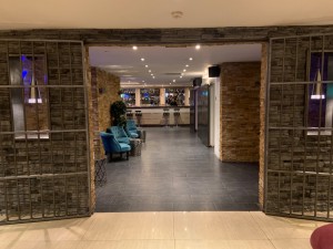 View of entrance of bar from hotel lobby. Doors pull to open from centre with no handle.