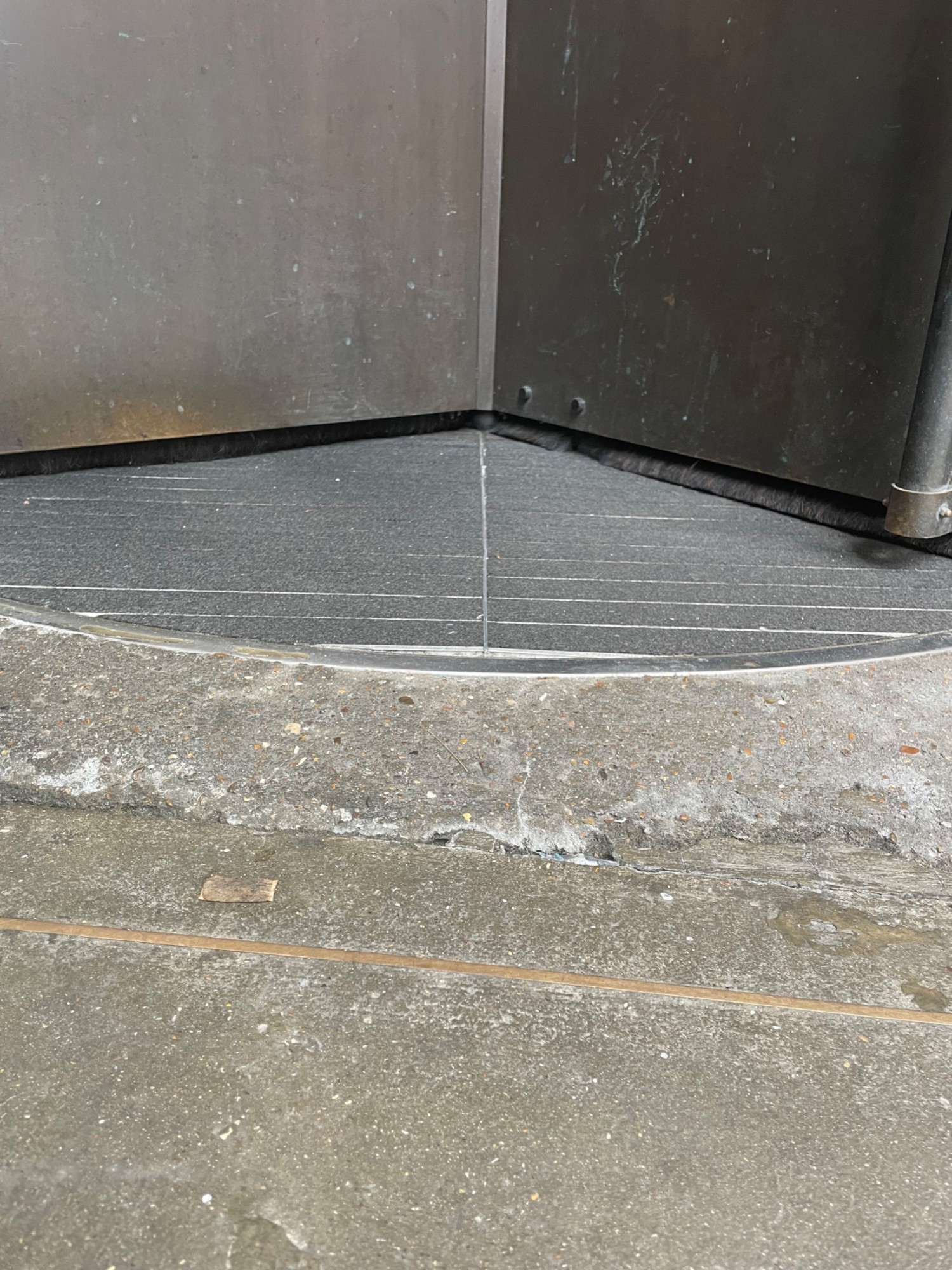 Small built in ramp leading up to revolving doors.