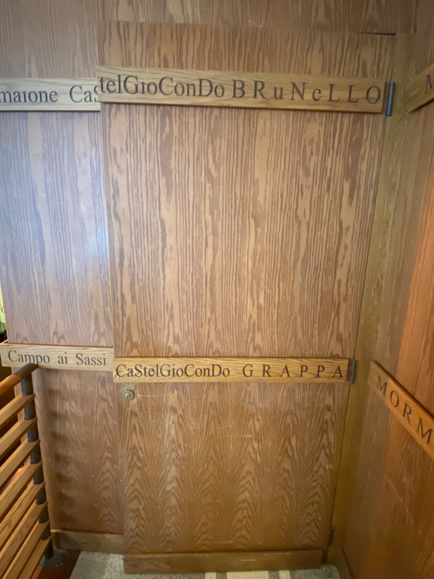 Brown wooden pull door with lock on left side.