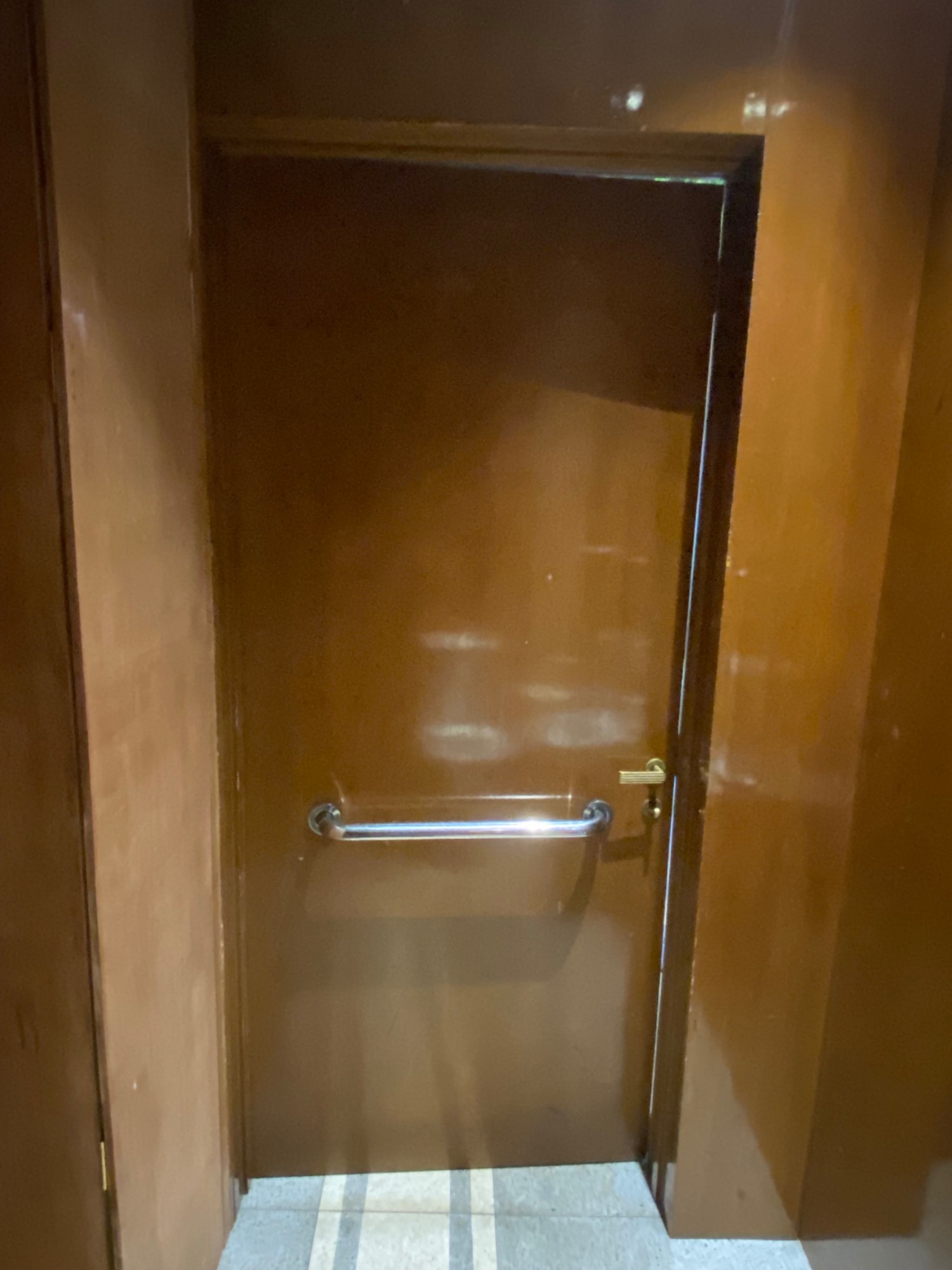 Inside bathroom straight ahead from bathroom. Handle on right side.