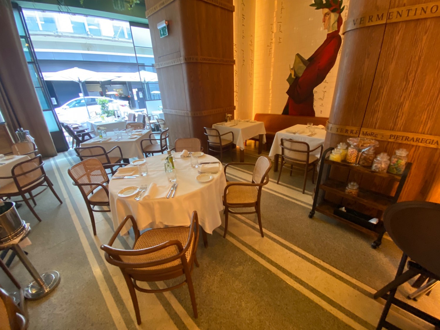 Go down pathway that veers to right to look left. Tables & chairs up front. Half booth behind.