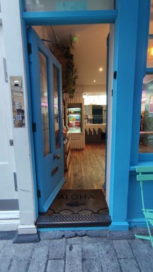 Glass door with blue frames ahead. Push to right to open.