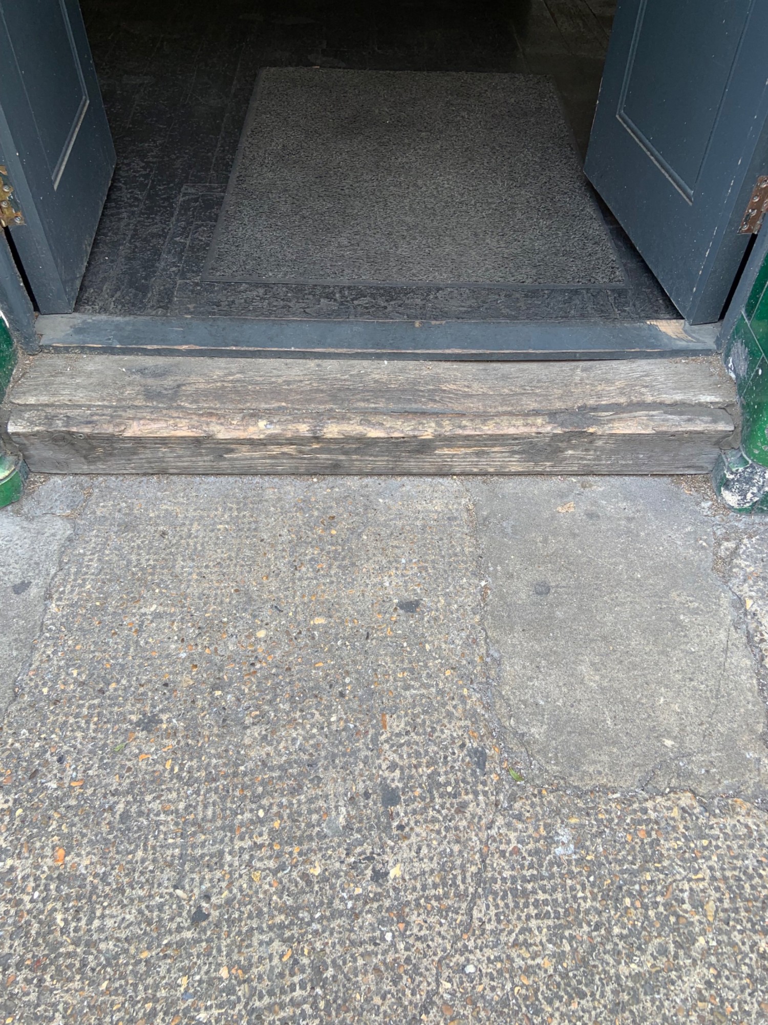 Step on threshold of the door.