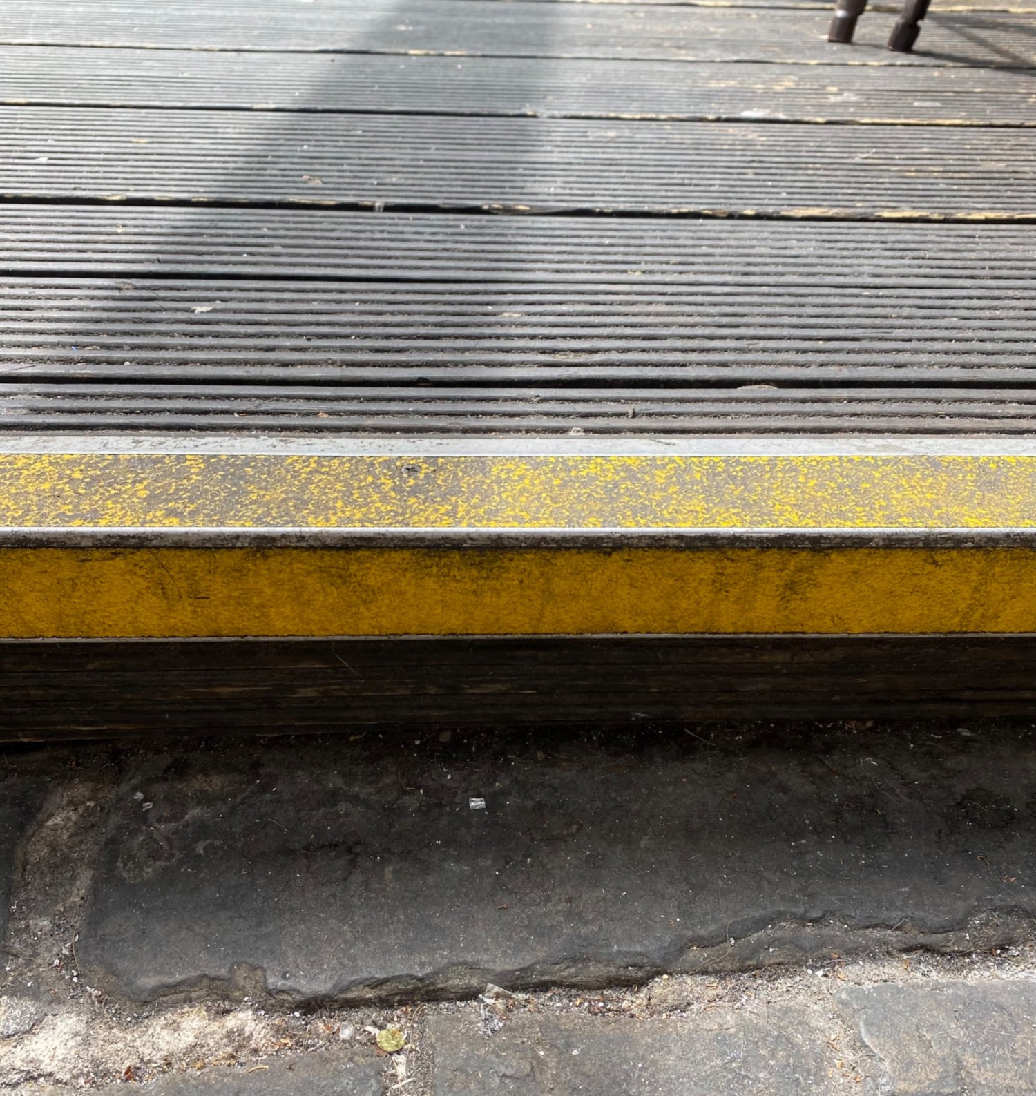 Step with yellow textured stripe to first seating platform.