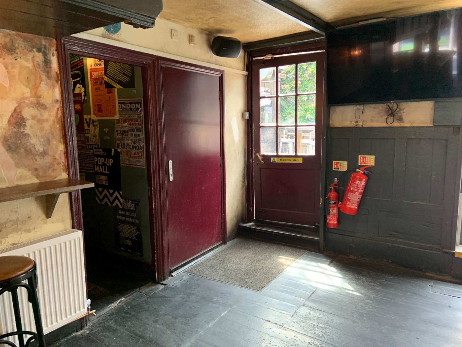 View of open pathway to bathroom in back left corner of main area.