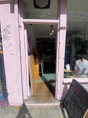 Glass door with handle on right. Push to open.