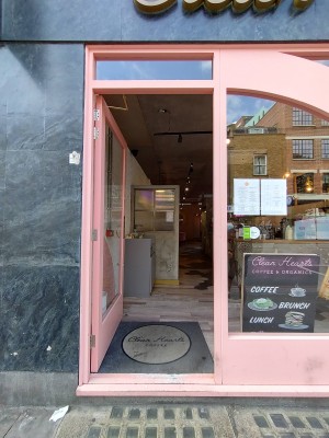 Glass door with metal pad on right. Push to open.
