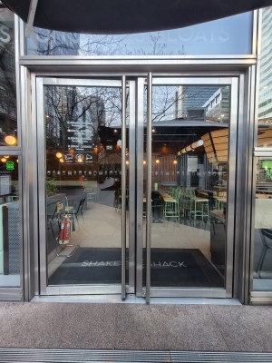 Silver framed glass doors. Push silver handles in centre to open.