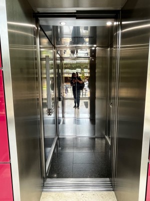 Accessible lift on left of staircase. Control panel on left.
