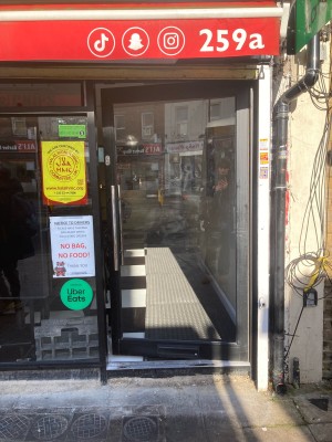 Glass door ahead. Pull to open via handle on left.