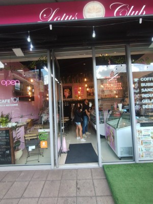 Glass door with plastic frame. Push open to left, handle right. Built-in ramp before and after door and small bump at door.