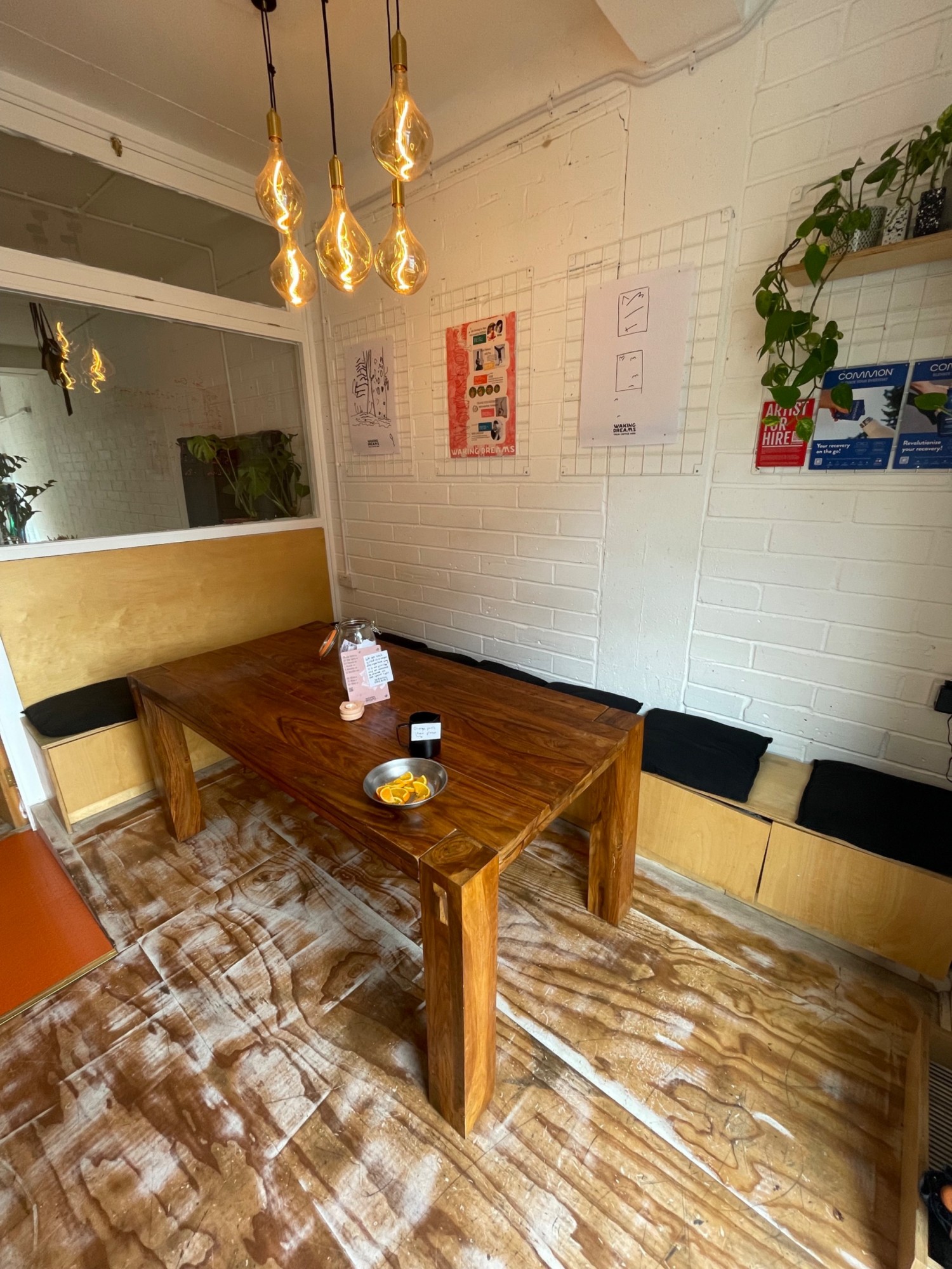 Taken from entrance facing right. In middle table and half booth around it to right.