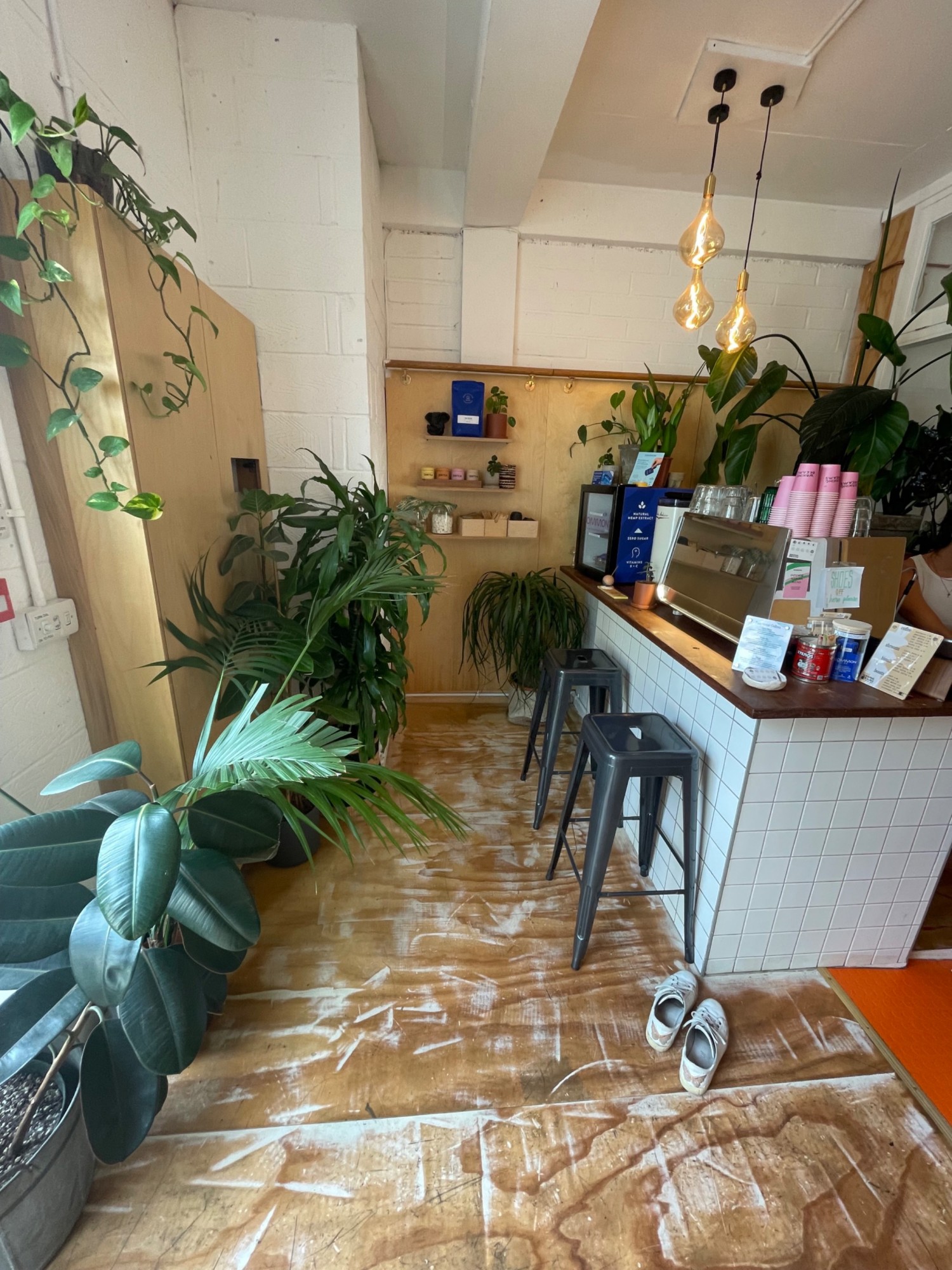 Taken from entrance facing left. In middle path. On right stools at counter and retail area.