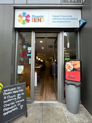 Glass door with silver vertical handle on left. Push to open.