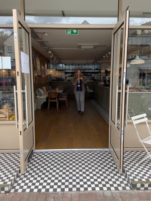 Glass door with beige frame pull to open from centre where doors meet.