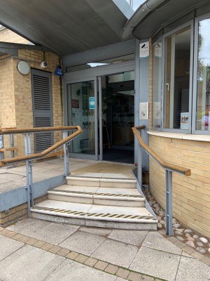 View of steps before main entrance to right side of entrance. Three steps before landing area with handrails to each side. Door straight after steps.