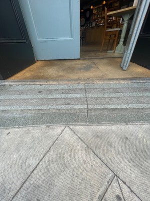 One step and then small bump before door.