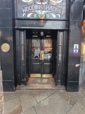 Black framed glass doors ahead. Pull golden handles in centre to open.