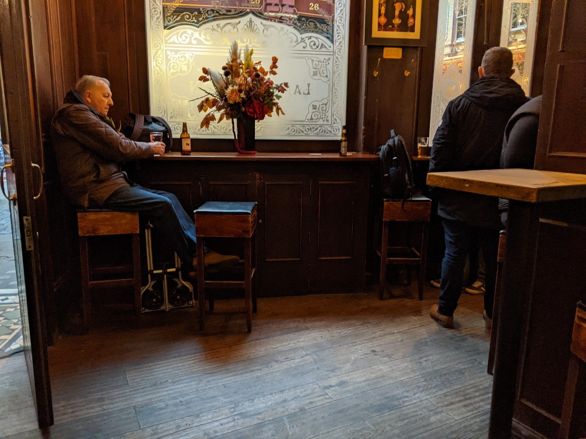 From end of bar facing right. Alternative entrance on left. High tables with stools ahead.