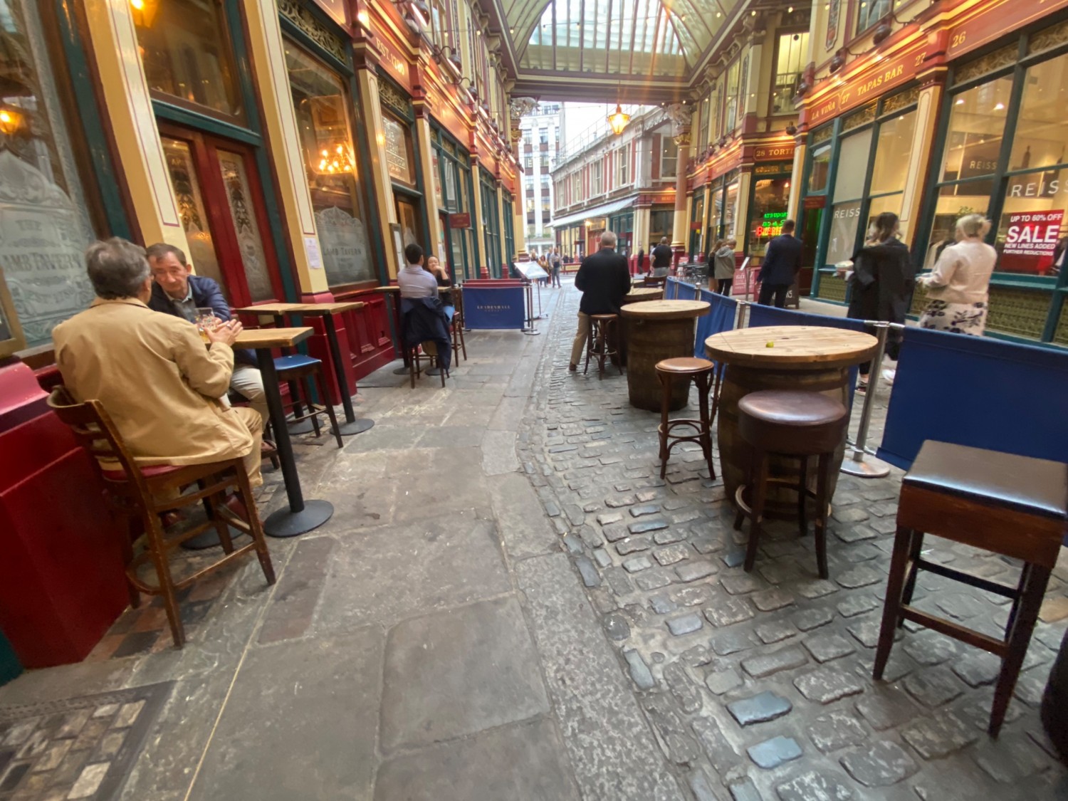 Outdoor area on right side of entrance. High seating on left & right with pathway in middle.