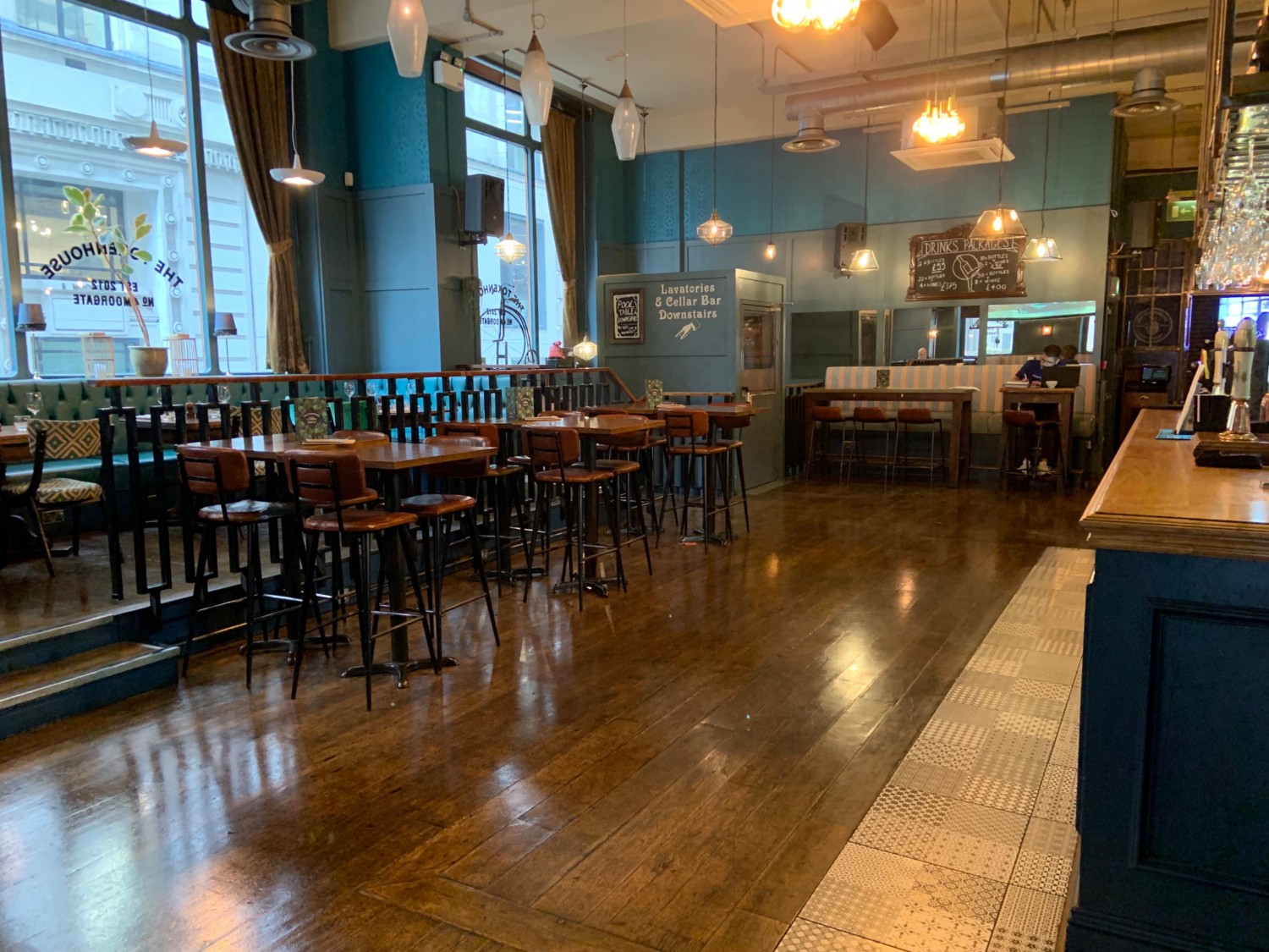View from start of bar looking ahead, bar to right, wide pathway centre, stairs to upstairs in front left following by seating lining dividing wall.