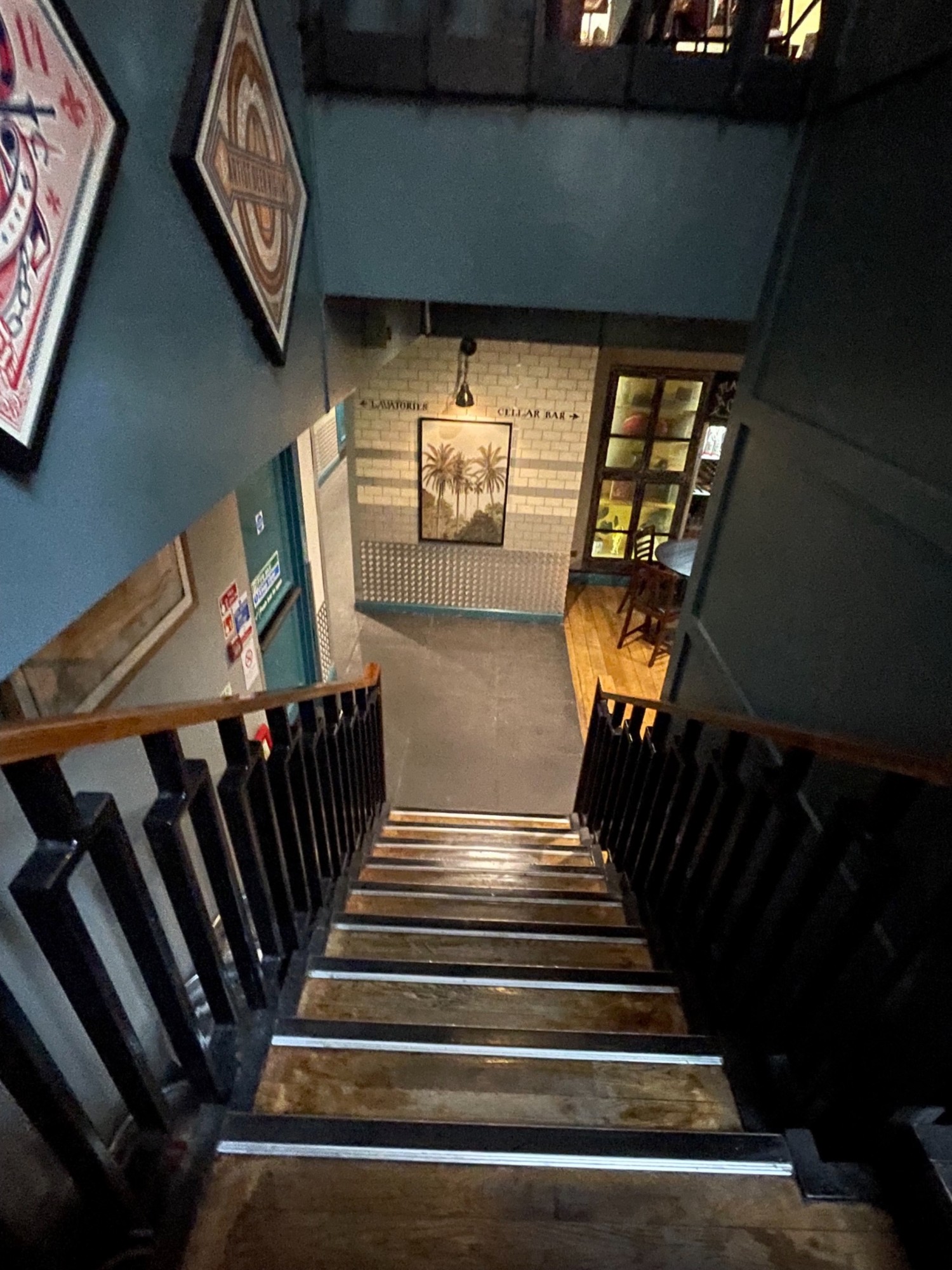 From the landing looking right at downstairs. Hand rail on left and right.
