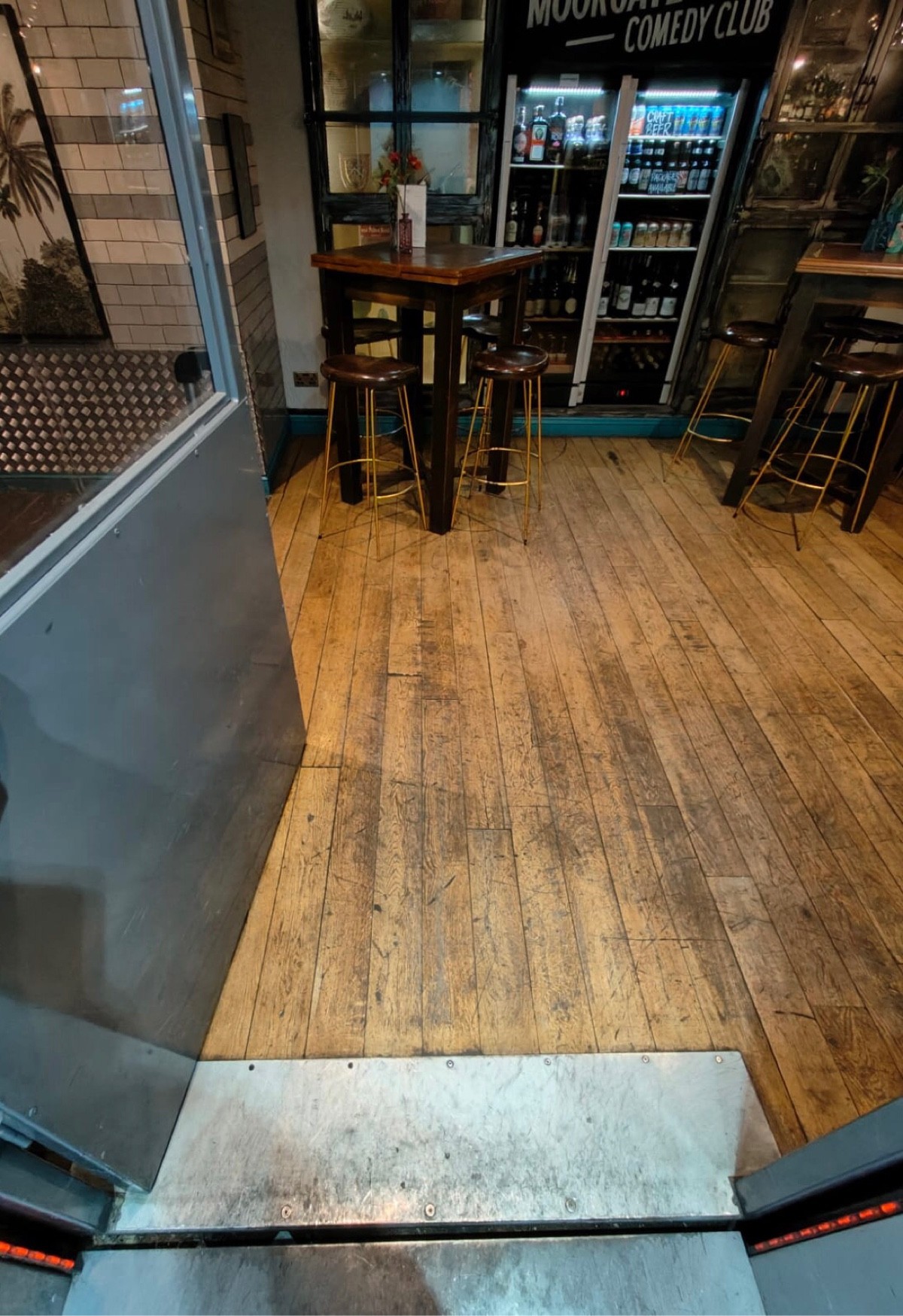 From inside lift facing straight. Push lift door  on right to open. Small bump at foot of lift door.