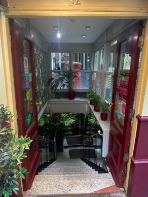 Red-framed double glass push doors (handles in middle).