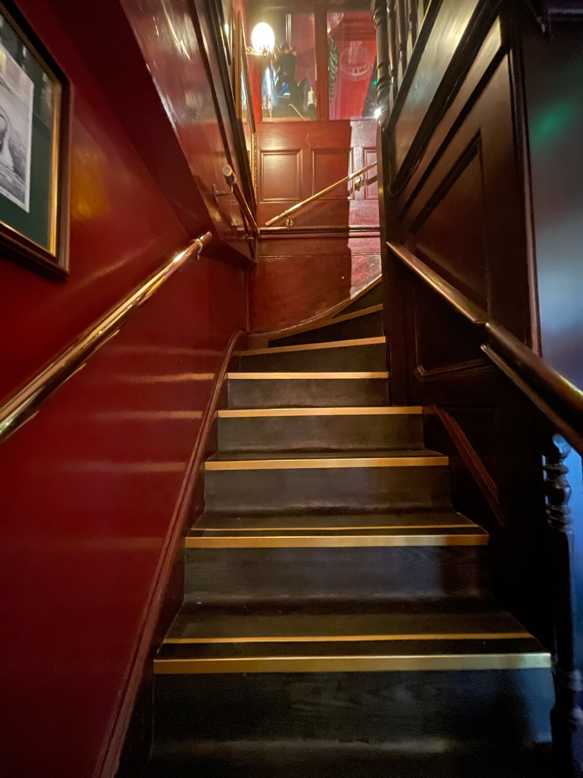 From curve of stairs facing right. Stairs continue to go up and curve right. Handrails on either side.