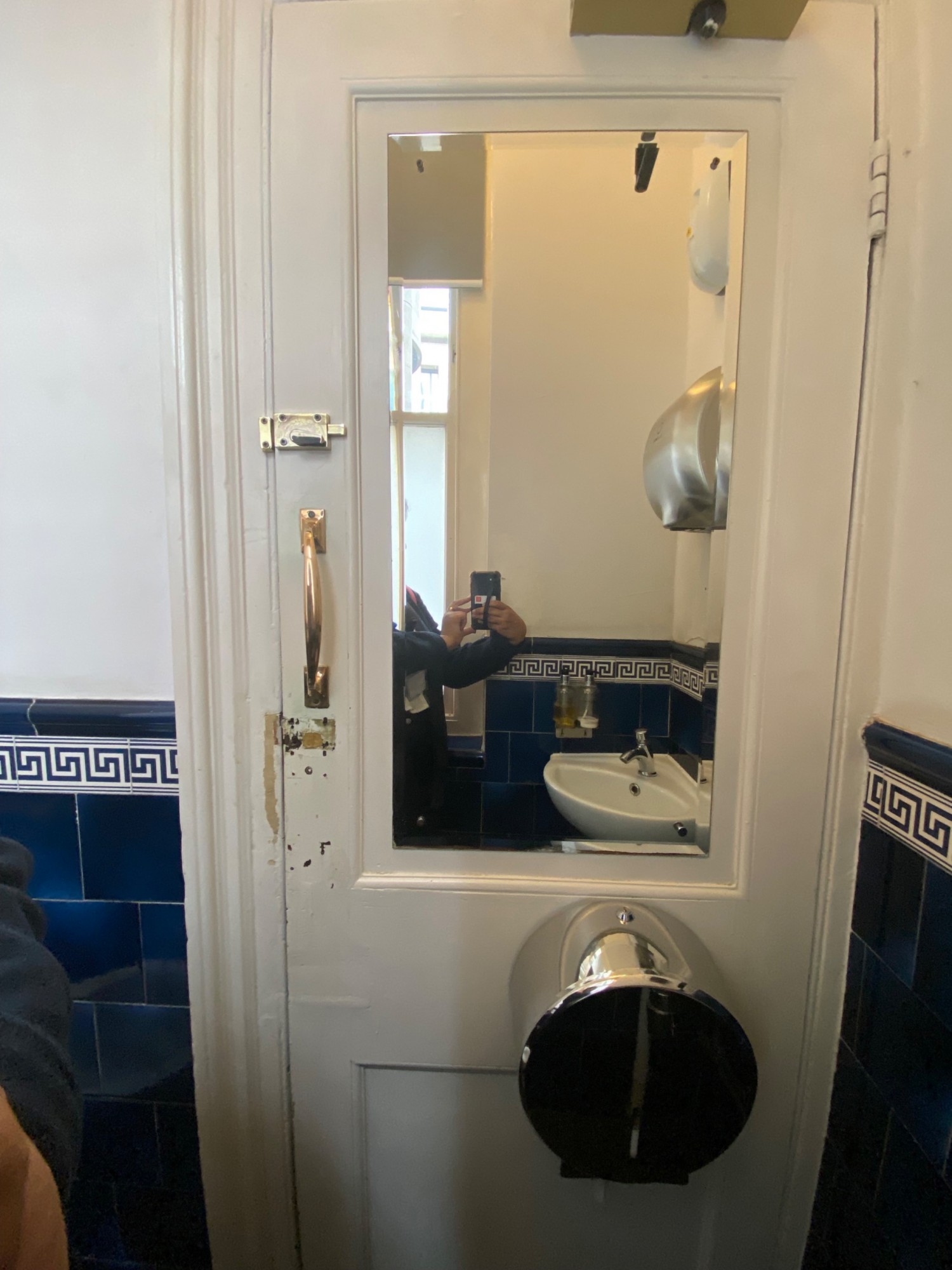 Back of bathroom door. Pull to open on left. Mirror in center.