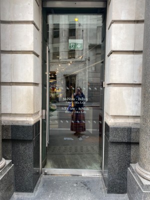 Glass pull door with handle on right. Small bump along front.