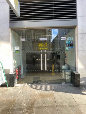 Front of double glass doors. Pull metal handles in center to open.