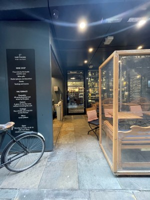 From street facing venue. Opening ahead of entrance doors. Outside seating on right.