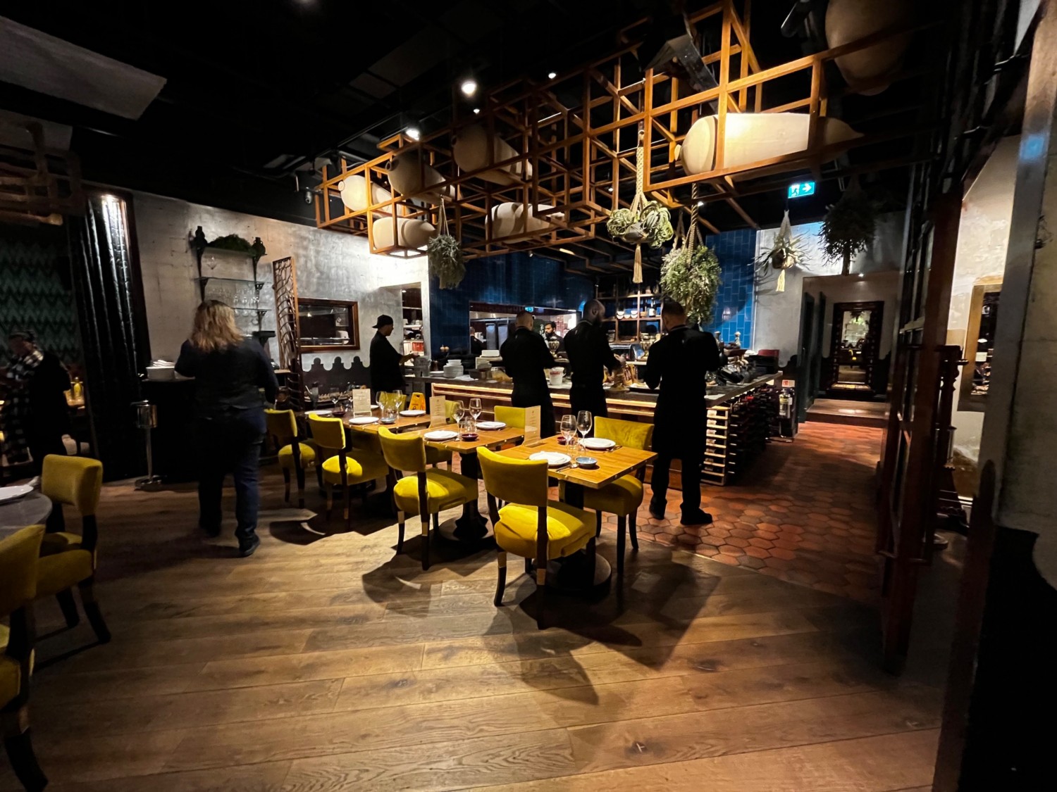 Continuation of main area to right. Tables and chairs in front of open kitchen area. Private room on immediate right.
