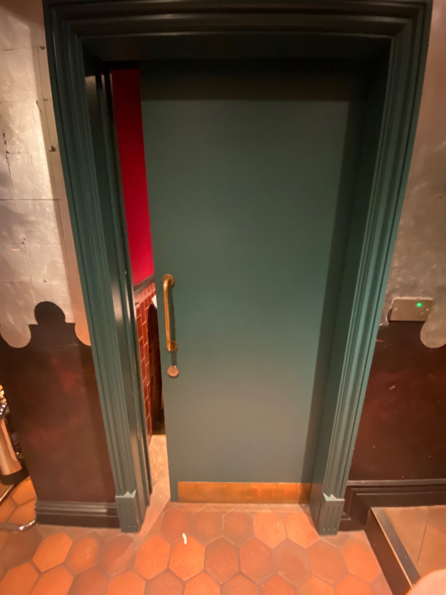 Facing entrance. Sliding door. Handle on left. Pull to the right to slide open. Inside, handle on right. Lock underneath handle.