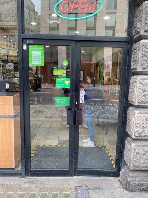 Black-framed glass doors. Push black metal handles in centre to open.