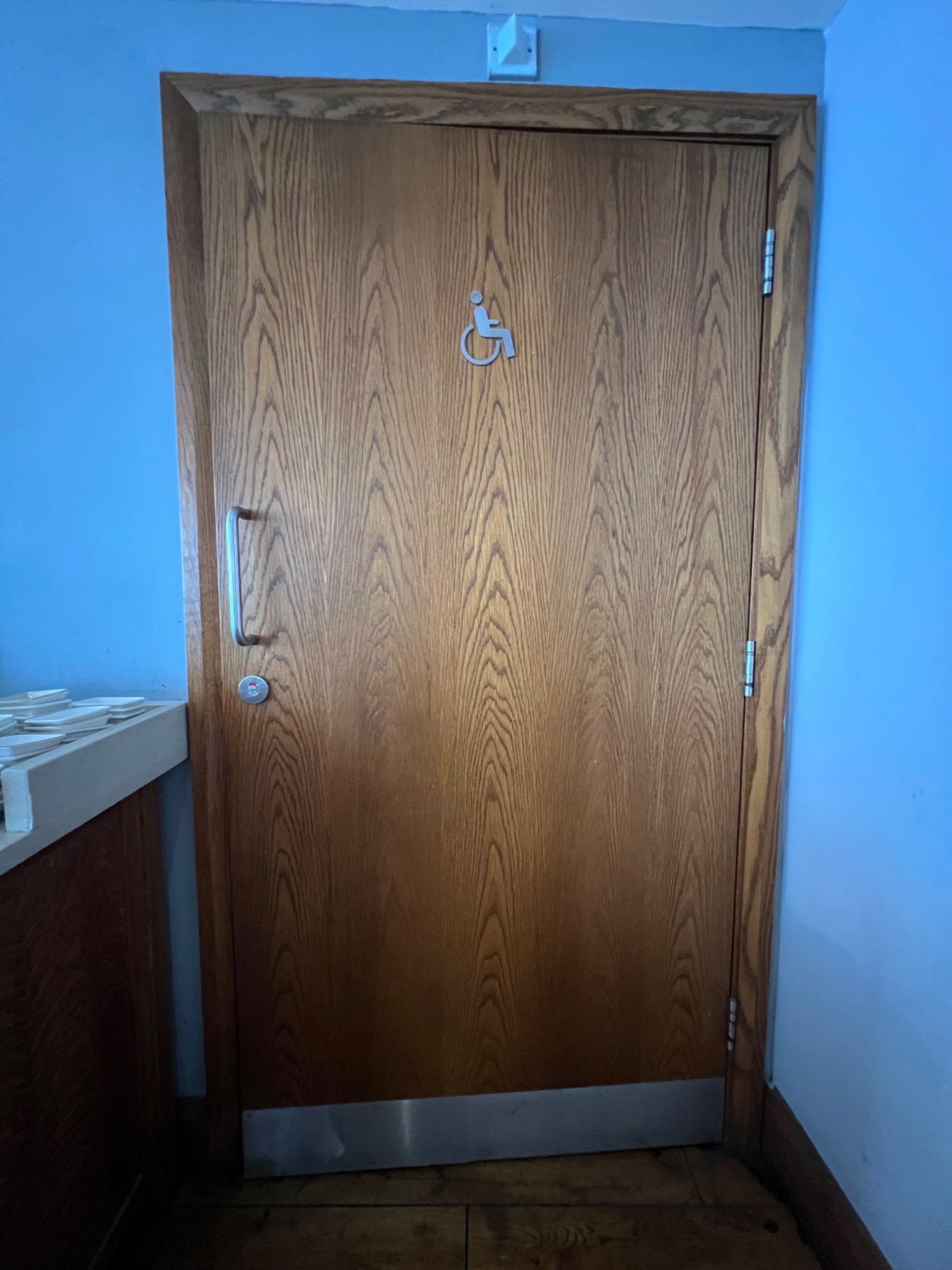 Outside of bathroom door. Handle to the left, door opens outwards left to right.