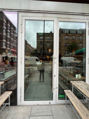 White framed glass door. Pull silver handle on right to open.
