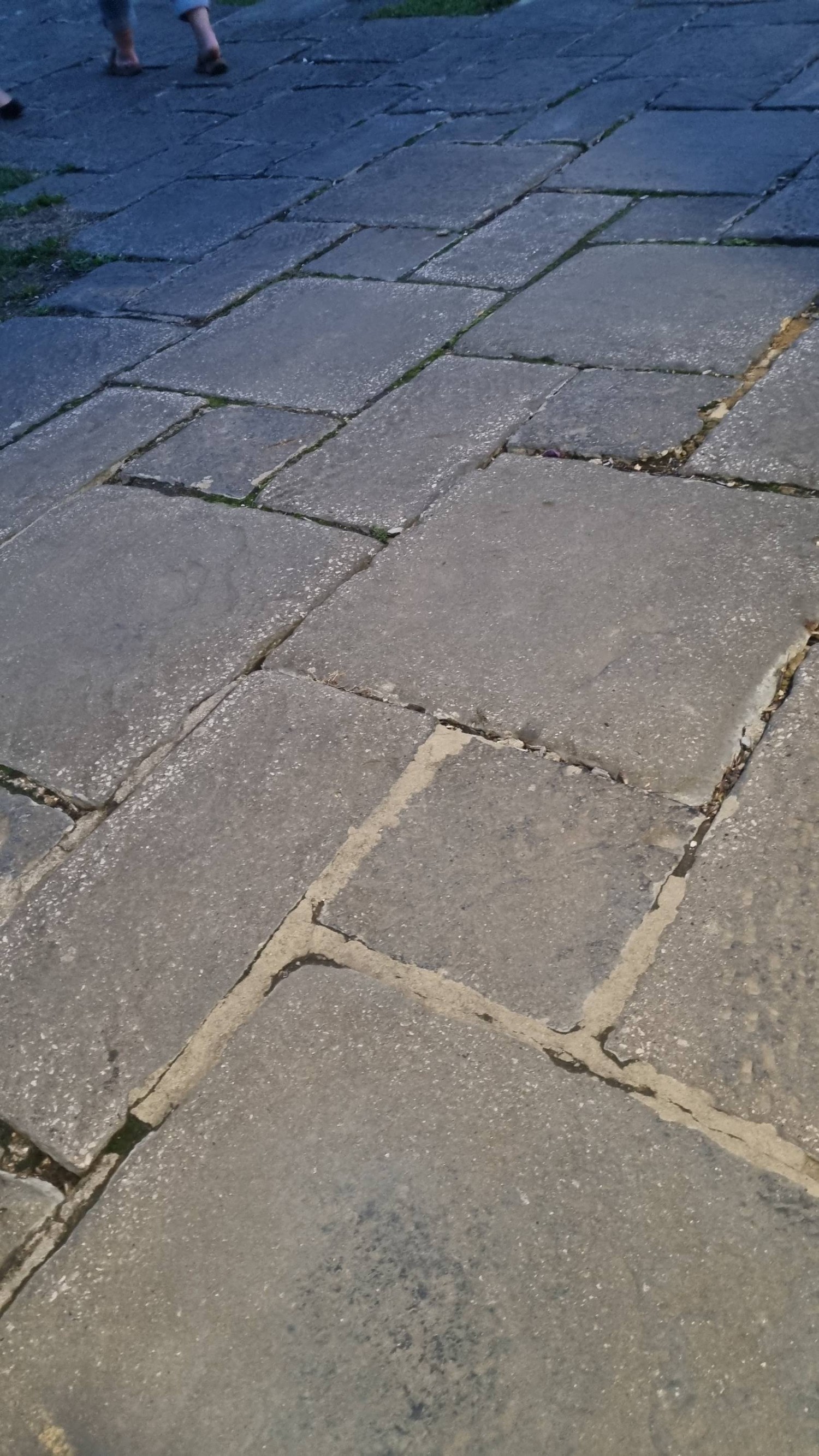 Paving slabs. Deep cracks. Potential trip hazard