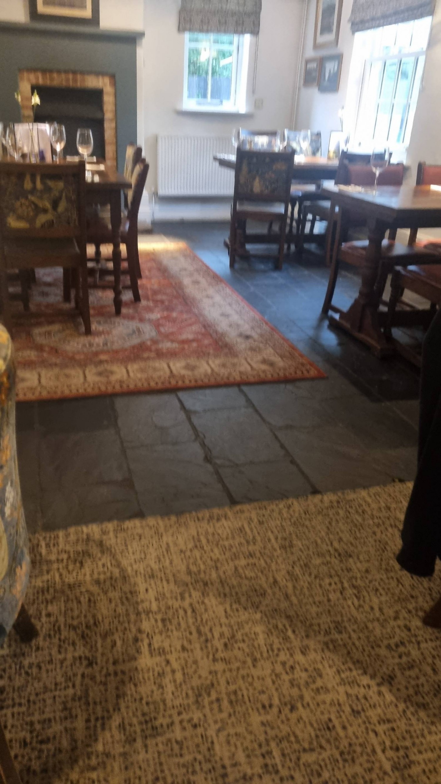 Seated height tables. Carpet rugs. Busy space