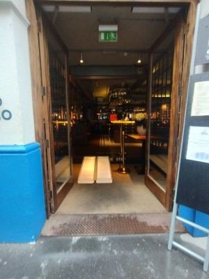Double glass door with wooden frame. Push open from middle.