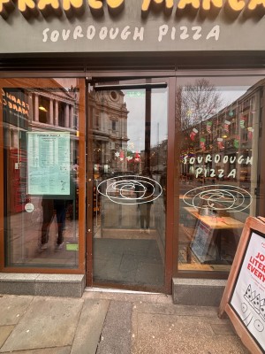 Glass door with brown frame ahead. Push at left to open.