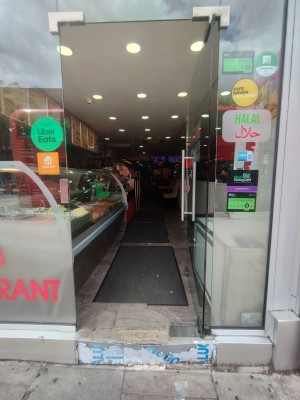 Glass door ahead. Push silver metal handle on left to open.
