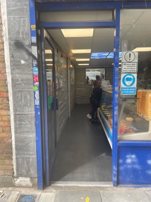 Single door with blue frame. Push door metal
handle on right to open.