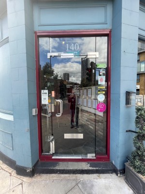 First door. Push door open from the left.