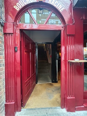 Red wooden door. Push from right to open.