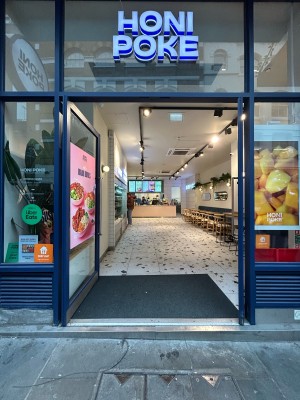 Glass doors with blue frame. Push silver handle in middle to open.