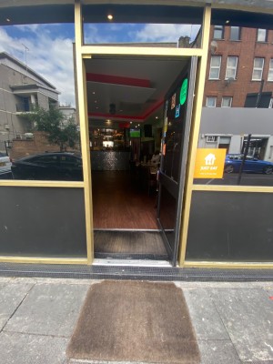 Facing entrance straight ahead. Door handle on left, push to open.