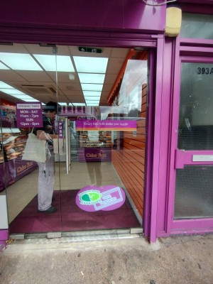 Glass door ahead. Push open via metal handle left.